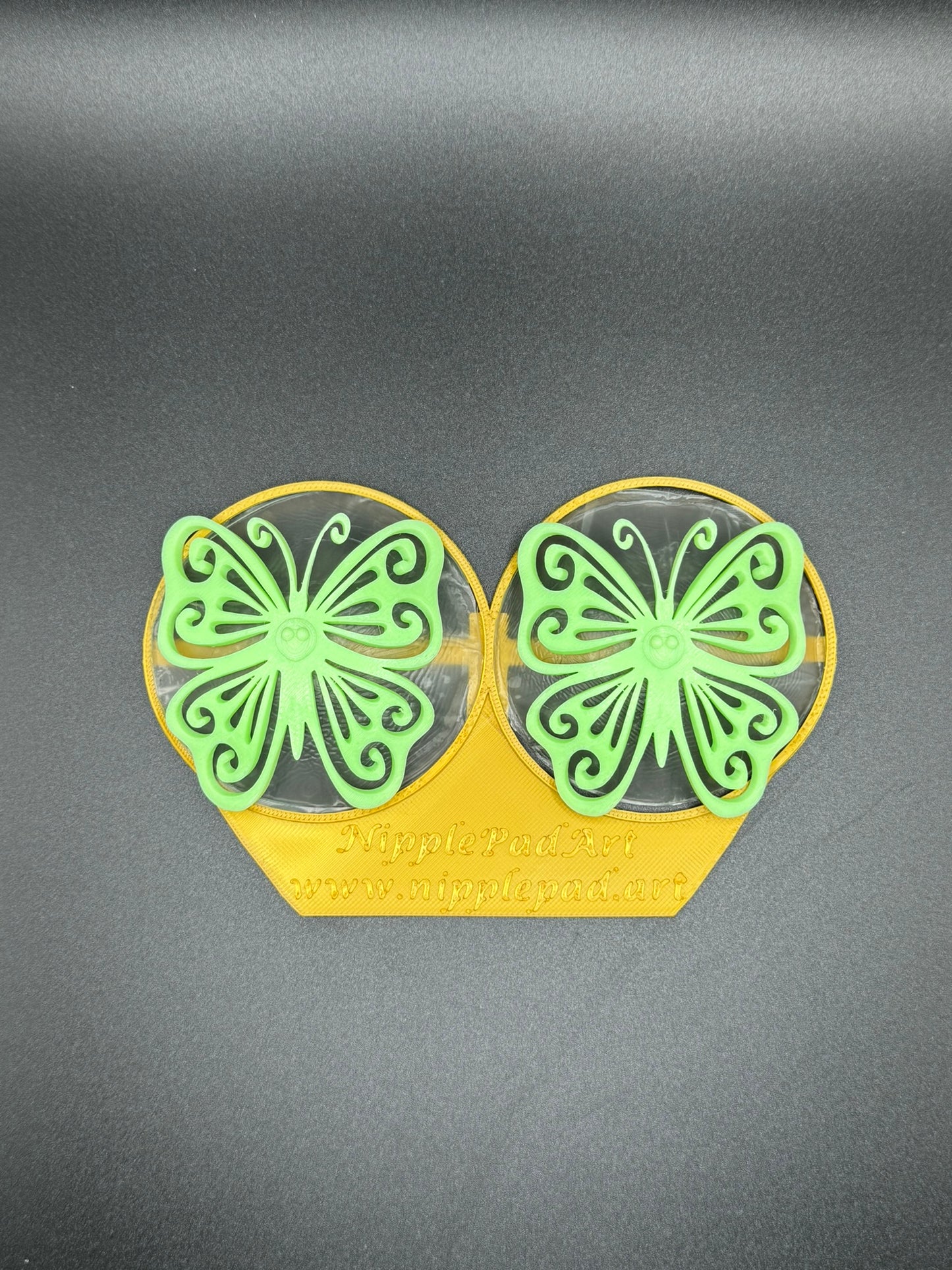 Wiederverwendbare Nippelpads mit Schmetterling-Design - UV-aktiv - Neongrün